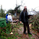 Jevern Gillispie (right) helps bring out belongings from Lisa Hill and Elunion Cooper’s home after a tornado touched down Feb. 11, 2013, in Hattiesburg, Miss. (Sean Gardner/Getty Images)